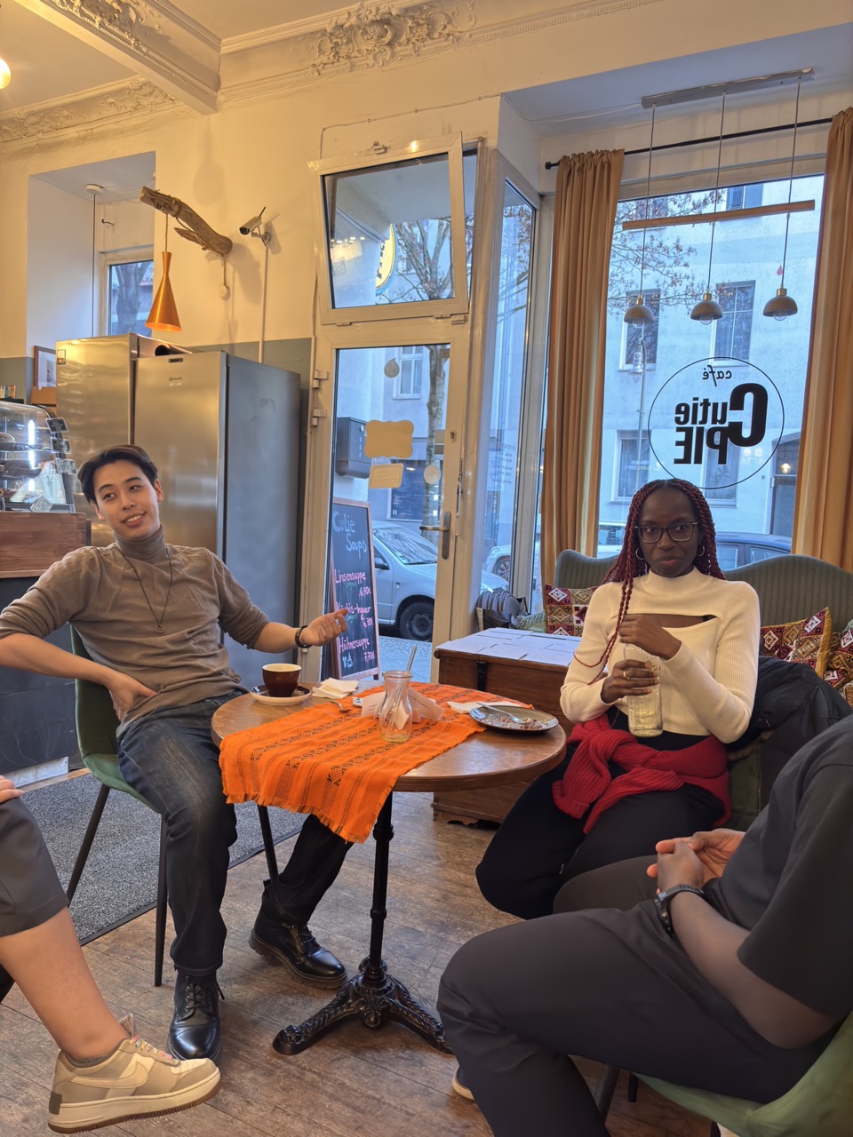 Members chatting around a table at Cutie Pie Cafe