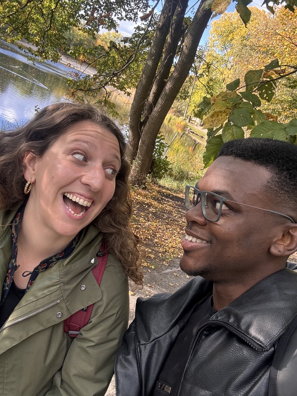 Two members sharing a playful moment on a park walk
